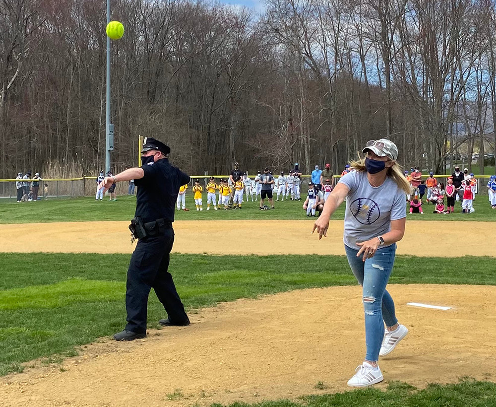 Kevin Shannon, a school resource officer at Crispell Middle School, and Lauren Thoelen, mother of a Pine Bush Little League player, throw out the first pitch at Pine Bush Little League’s opening day ceremony at Crawford Town Park on Saturday.